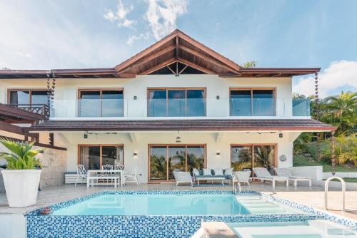 a villa with a swimming pool and a house at Villa with 3 bedrooms private pool and ocean view in Santa Bárbara de Samaná