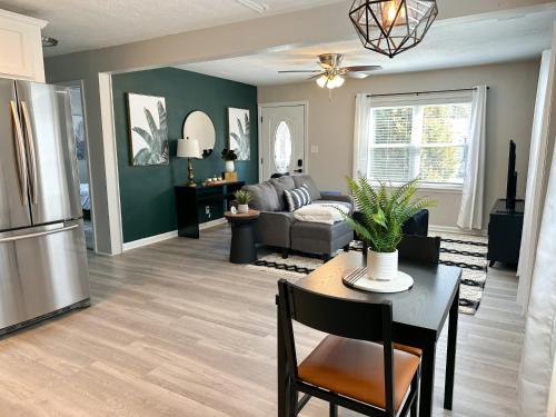 a living room with a couch and a table at Bluegrass Bungalow in Louisville