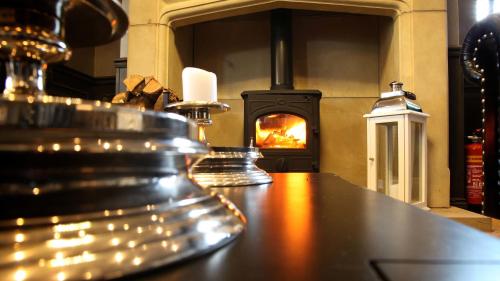 a bar in front of a fireplace with a stove at The Eccleston Hotel; BW Signature Collection in Saint Helens
