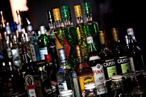 a group of bottles of alcohol sitting on a bar at The Eccleston Hotel; BW Signature Collection in Saint Helens