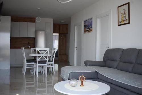 a living room with a couch and a table at Buskovic Bella Vista in Dobra Voda