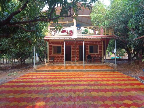 a house with a rug in front of it at Gazebo Holiday Home in Srīvardhan