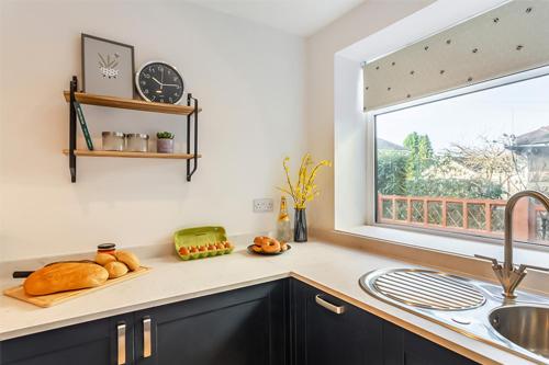 a kitchen counter with a sink and a window at The Harrogate House - 4 Bed Townhouse in Harrogate