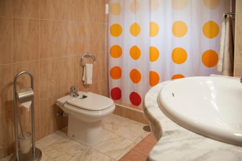 a bathroom with a toilet and a shower curtain at Quinta do Santo by LovelyStay in Santo da Serra