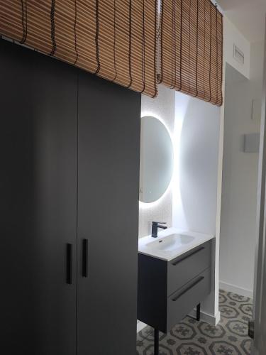 uma casa de banho com um lavatório e um espelho em Supl. 22 Cabernet em Novelda