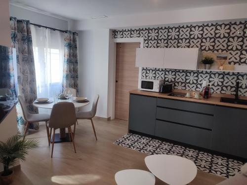 a kitchen and dining room with a table and a dining room at La Noguera Rural Suite in Güéjar-Sierra