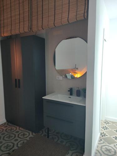 a bathroom with a sink and a mirror at Supl. 22 Cabernet in Novelda