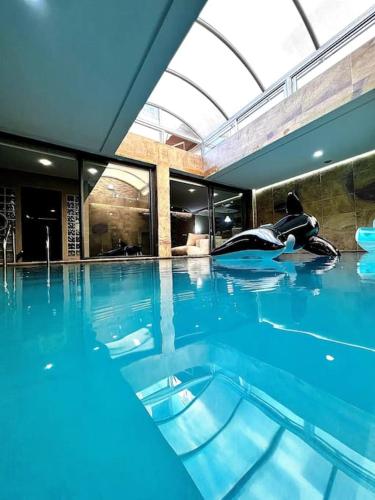 a person laying on the floor of a swimming pool at Nassali - Luxurious Beachfront Villa with Private Pool in Casablanca