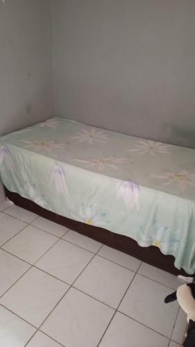 a bed in a room with a white floor at Kitnet recife carnaval 2024 in Recife