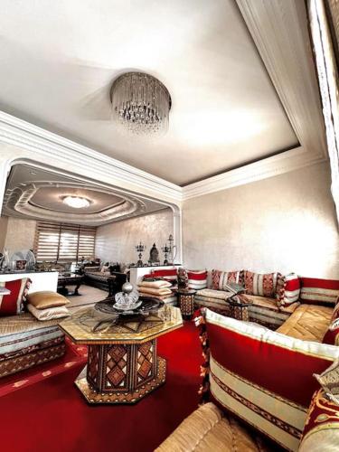 a large living room with couches and a table at Nassali - Luxurious Beachfront Villa with Private Pool in Casablanca