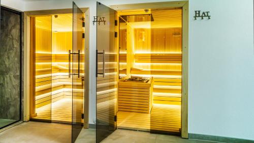 a walk in shower in a bathroom with wooden walls at Allgäu Residenz Natur & Spa GmbH in Wiggensbach