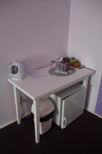 a small white table with acomputer on top of it at Penzion U Lucerny in Jindrichuv Hradec