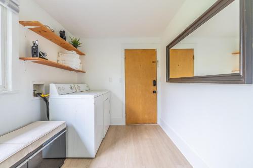 a small kitchen with a door and a window at Capitol Hill Cutie in Seattle