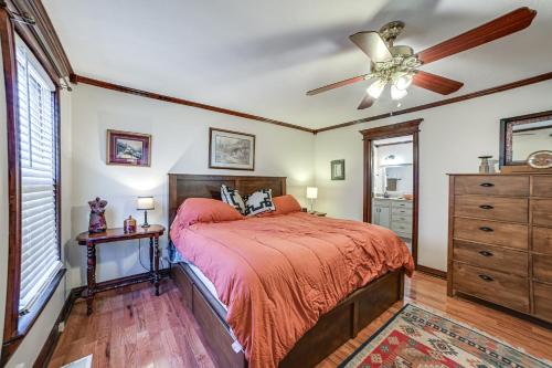 a bedroom with a bed and a ceiling fan at Clarksville Home with Porch and Fishing Pond Access! in Clarksville