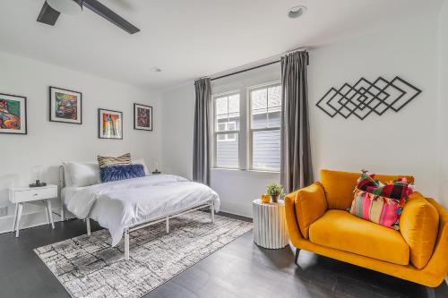 a bedroom with a bed and a couch and a window at Capitol Hill Cutie in Seattle