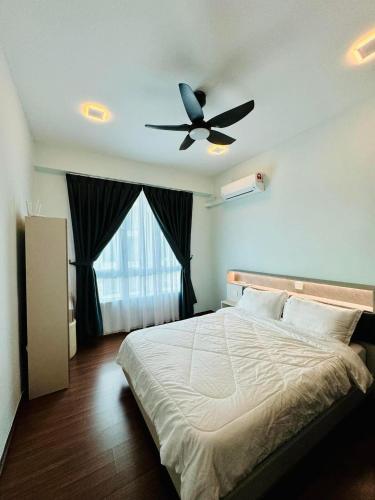 a bedroom with a bed with a ceiling fan at Sri Indah condominium in Sandakan