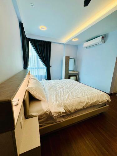 a bedroom with a bed with a dresser and a window at Sri Indah condominium in Sandakan