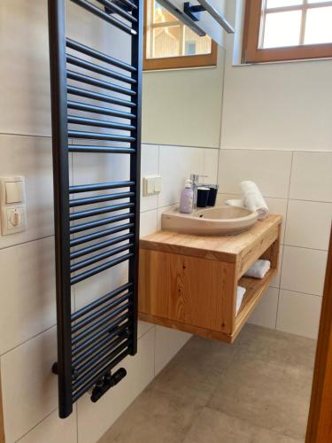 a bathroom with a sink and a mirror at Haus am Mühlenweg in Altenmarkt im Pongau