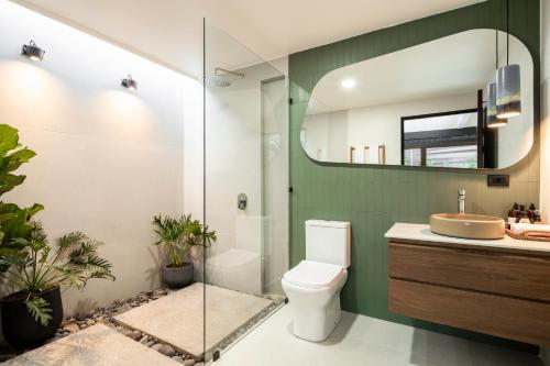 a bathroom with a toilet and a sink and a mirror at BAUMA in Fortuna