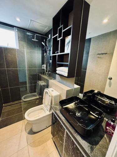 a bathroom with a toilet and a sink at Sri Indah condominium in Sandakan