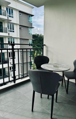 a patio with a table and chairs on a balcony at Sri Indah condominium in Sandakan