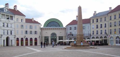 a group of buildings with a fountain in a courtyard at *SPACIOUS APARTMENT DISNEYLAND PARIS* in Serris