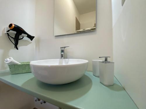 a bathroom with a white bowl sink on a counter at Le casette di Frà Host and Go in Santa Severa