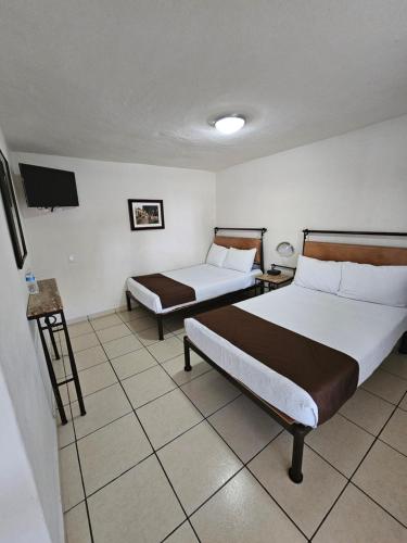 Letto o letti in una camera di Hotel Ejecutivo Aeropuerto
