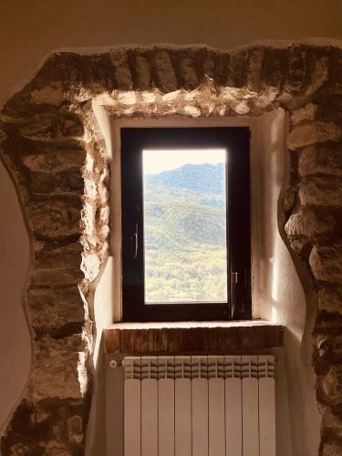 a window in a stone wall with a radiator at Torretta Margiotta in Picinisco