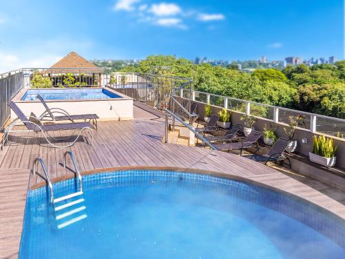 a swimming pool on top of a building at Tarobá Hotel in Foz do Iguaçu