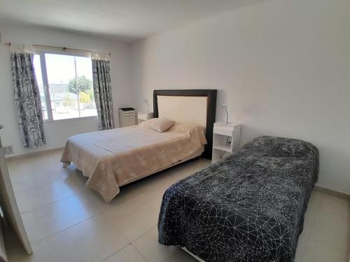 En eller flere senge i et værelse på Alojamiento Mi casita