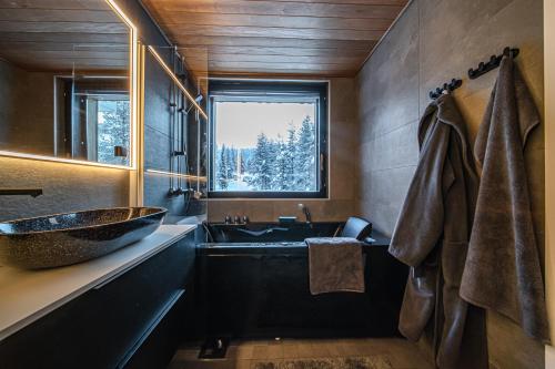a bathroom with a large sink and a window at Slopeside Bliss C21 Levi Center by Aavalevi in Levi