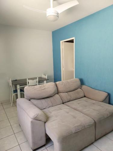 a living room with a couch and a table at Flat Pé de Mamão in Campinas