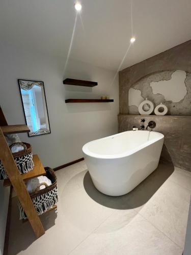 a bathroom with a large white tub in a room at Casa 63 Hotel Boutique & Spa in San Miguel de Allende