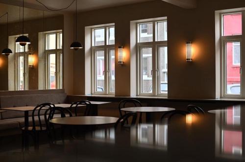 a restaurant with tables and chairs and windows at Hotel Local 101 in Reykjavík