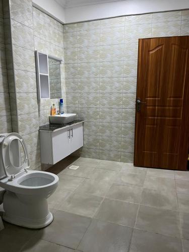 a bathroom with a toilet and a sink at The pine 1 bedroom house California plaza in Nanyuki