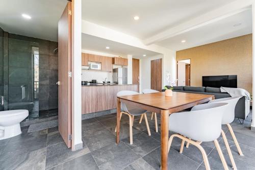 a kitchen and living room with a wooden table and chairs at Doctores Apartments by VH in Mexico City