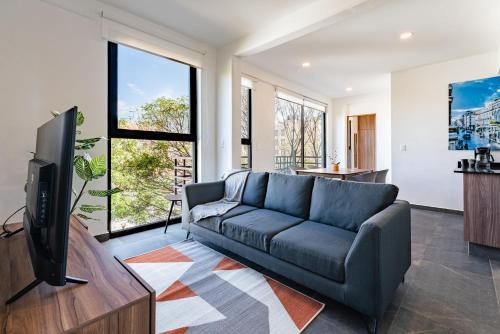 a living room with a couch and a tv at Doctores Apartments by VH in Mexico City