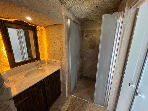 a bathroom with a sink and a mirror at Fairy Chimney House in Nevsehir