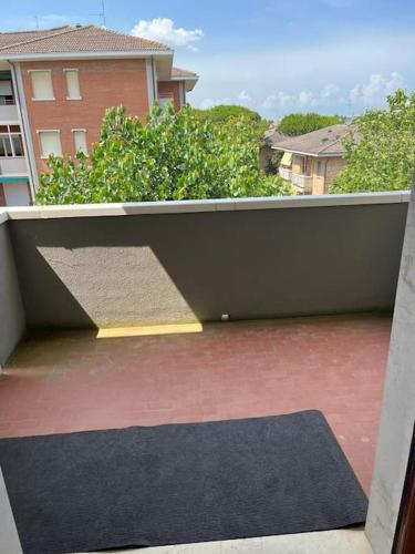 a view of a balcony with a rug on a patio at Grande e luminoso appartamento in Lido di Classe