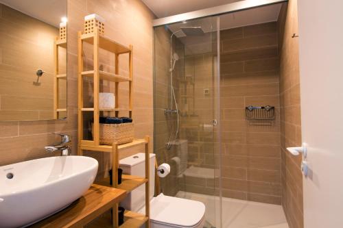 a bathroom with a sink and a toilet and a shower at Sea View Apartment Near The Beach in Fuengirola