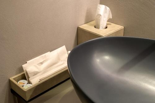 a bathroom with a sink and a box of tissues at Collina Luxury Relais in Clusone