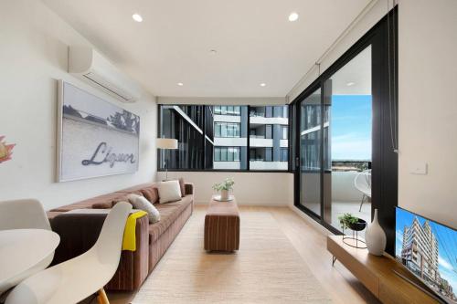 a living room with a couch and a table at Cool and Contemporary on the City Edge in Melbourne