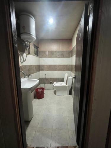 a bathroom with a toilet and a sink at Rupali home stay in Joshīmath