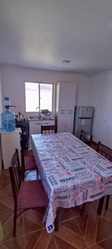 a kitchen with a table with a tablecloth on it at Cabañas Tres Islas in Punta de Choros