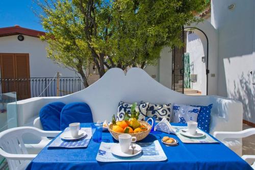 a blue table with a bowl of fruit on it at Holidays dream Praiano in Praiano