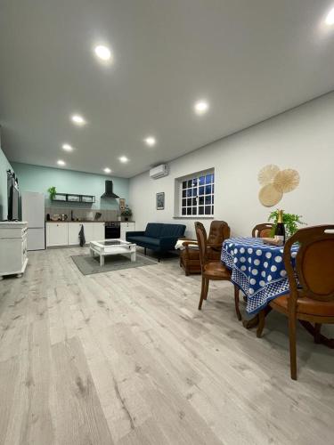 a large living room with a table and chairs at Porto Area, Poolside Sunsets of Vila Boa in Vilarinho