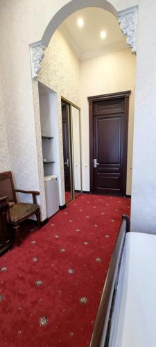 a hallway with a red carpet and a door at Oreanda Hotel in Odesa