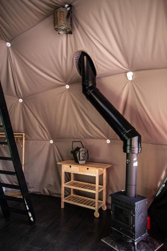 a black stove in a room with a tent at BUNNY GLAMP in Korbielów