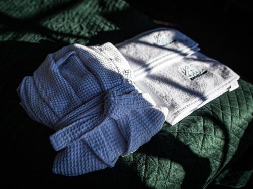 a pile of baby clothes sitting on a green blanket at BUNNY GLAMP in Korbielów